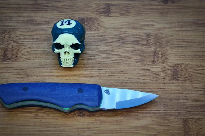 Blue denim micarta Broken Biscuit Carving Knife blade close up